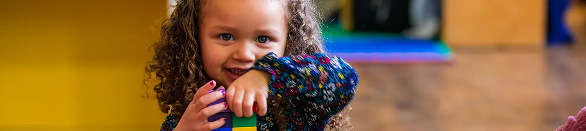 Toddler playing with building blocks