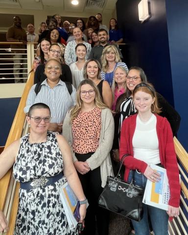 July 2023 Board Leadership Training participants pose on the stairs for a group photo